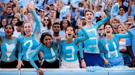 Students cheer at a football game.